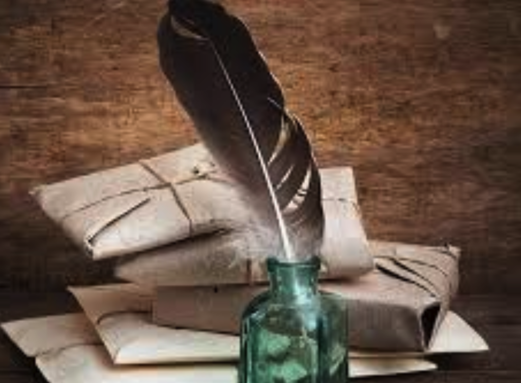 Picture of a bird's feather in a green ink bottle with packages tied with twine in the background.