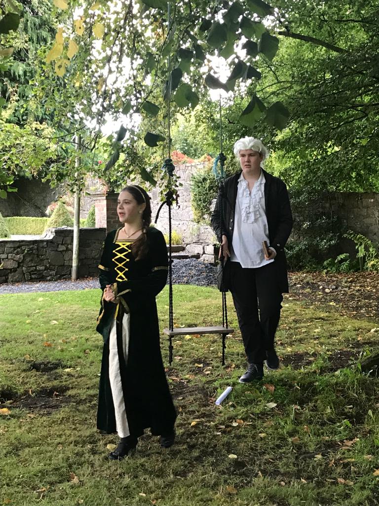 Lady and gent in a garden with period costumes