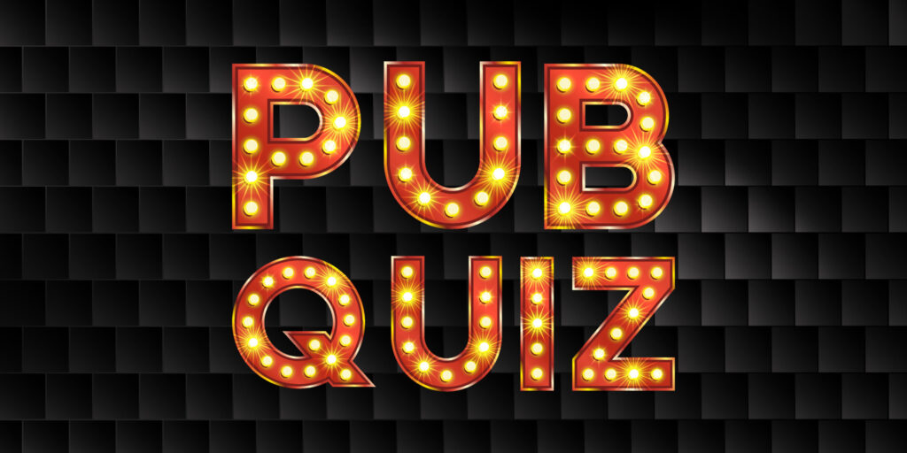 Pub quiz words written in orange light bulbs on a black background