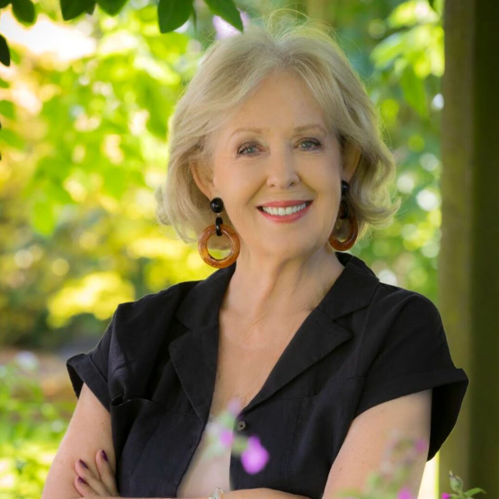 Photo of Mary O'Donnell standing with trees in the background.